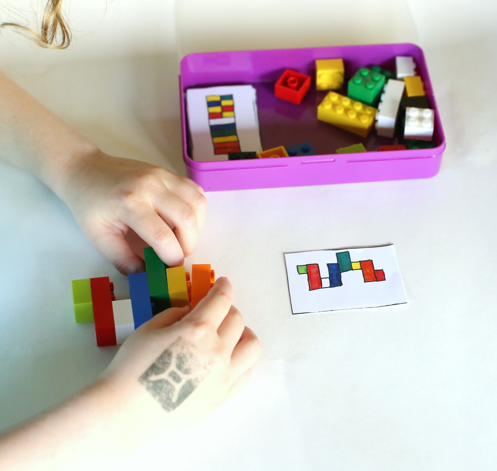 Kid playing with a portable lego kit