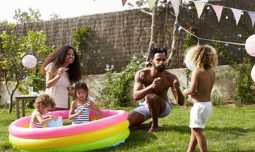 A family playing in a kiddie pool