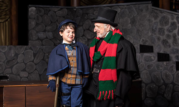 Scrooge and tiny Tim on stage